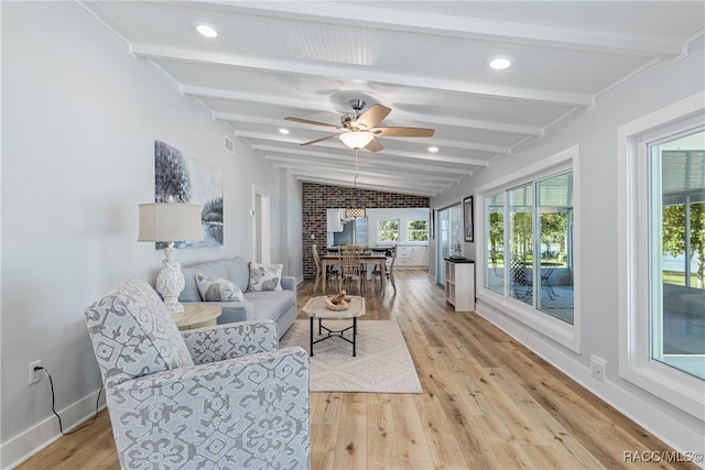 living room featuring vaulted ceiling with beams, ceiling fan, and light hardwood / wood-style floors