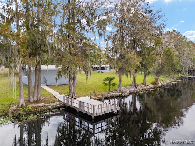 dock area featuring a lawn and a water view