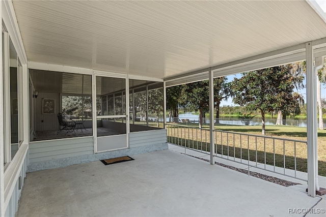 unfurnished sunroom with a water view