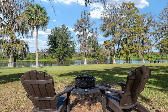 view of yard with a water view and a fire pit