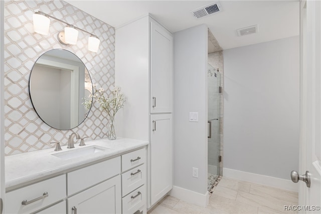 bathroom with vanity and a shower with door