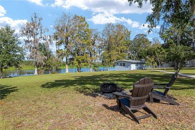 view of yard with a water view and a fire pit