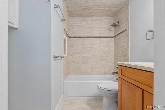 full bathroom featuring vanity, tiled shower / bath combo, and toilet