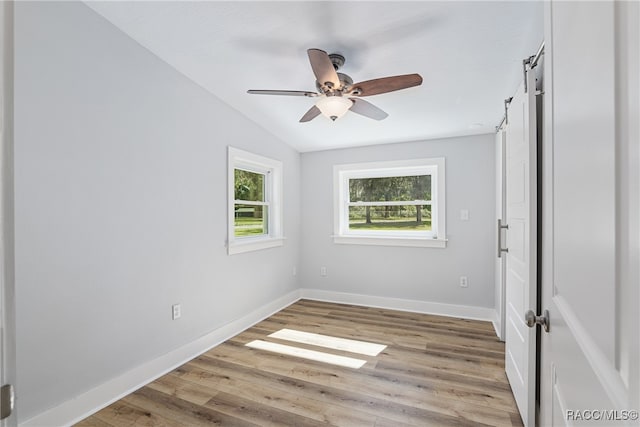 spare room featuring ceiling fan, light hardwood / wood-style floors, and vaulted ceiling