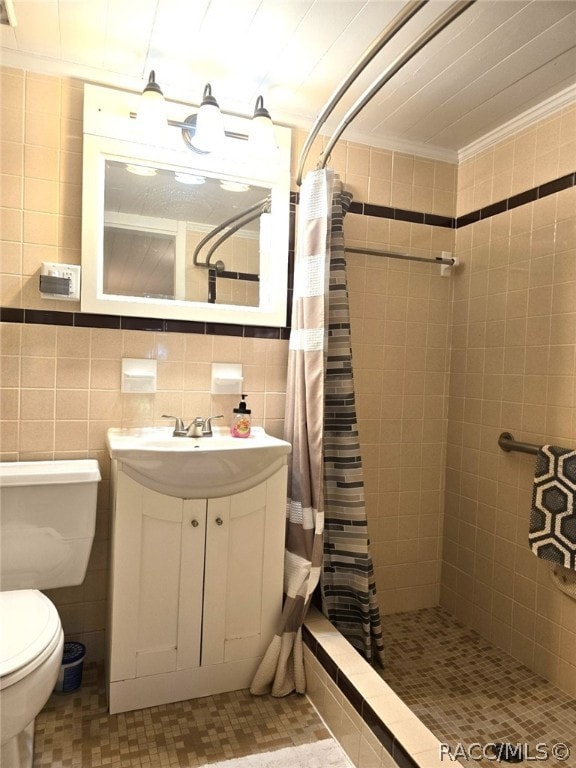 bathroom featuring vanity, decorative backsplash, toilet, tile walls, and walk in shower