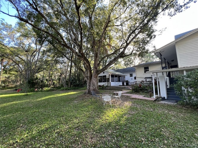 view of yard with a sunroom