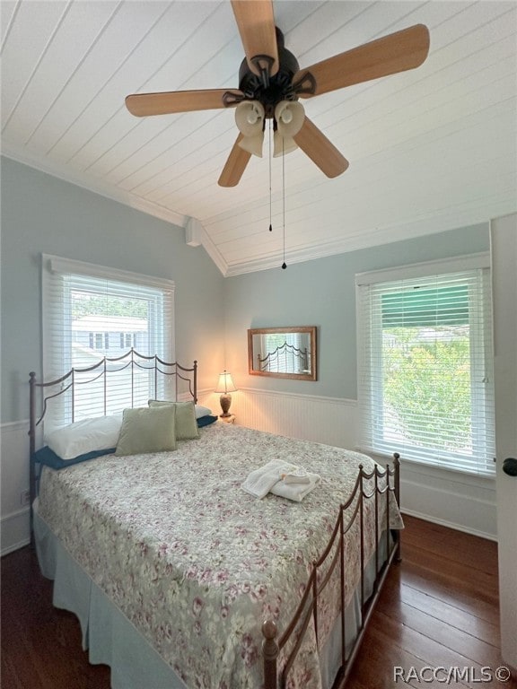 bedroom featuring wood ceiling, vaulted ceiling, ceiling fan, crown molding, and dark wood-type flooring