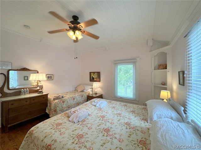 bedroom with ceiling fan, crown molding, wood ceiling, and dark wood-type flooring