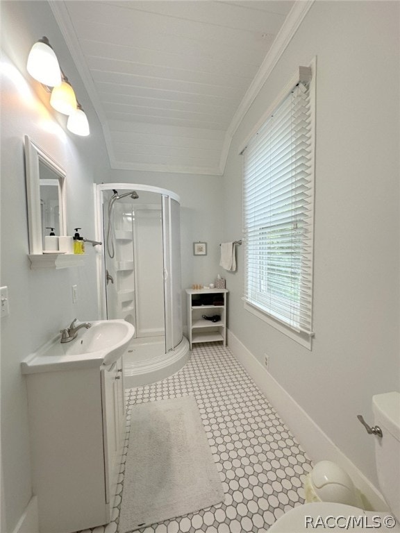 bathroom with vanity, crown molding, vaulted ceiling, toilet, and a shower with shower door