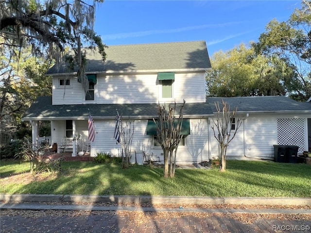 back of house featuring a lawn