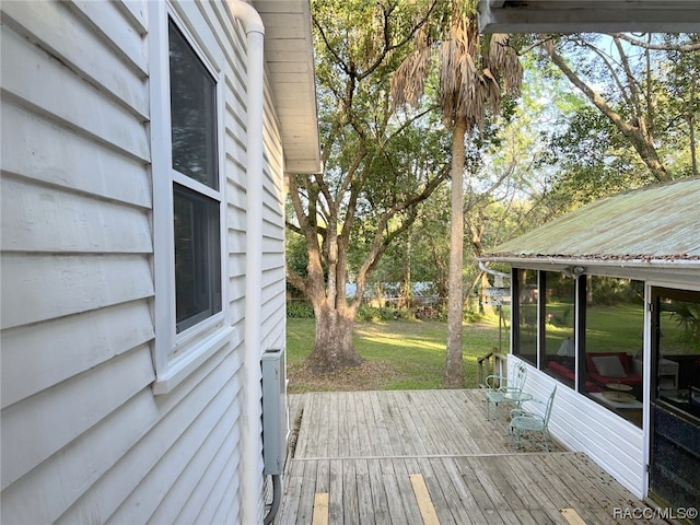 wooden terrace featuring a sunroom