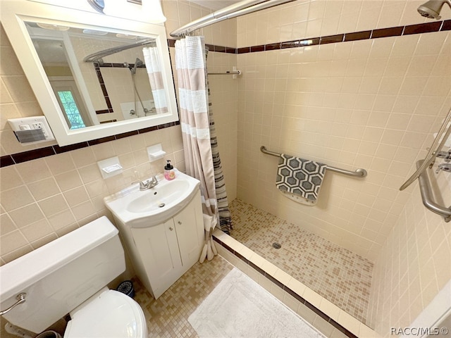 bathroom with tile patterned flooring, a shower with curtain, tile walls, and vanity