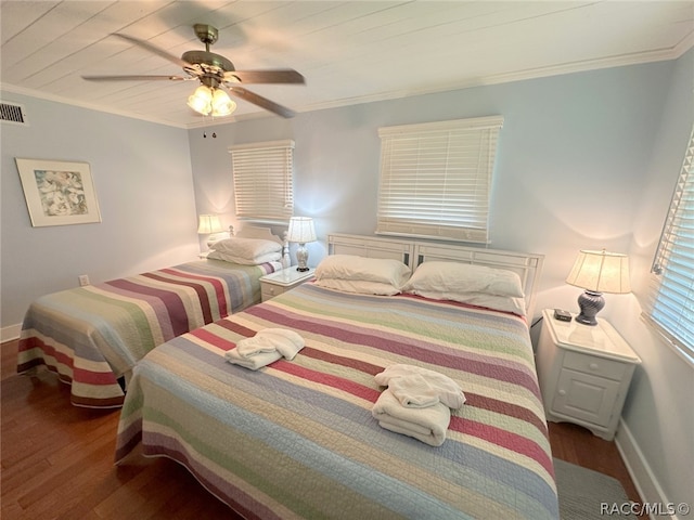 bedroom with hardwood / wood-style floors, ceiling fan, and ornamental molding