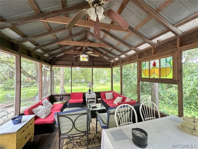 sunroom featuring ceiling fan and vaulted ceiling