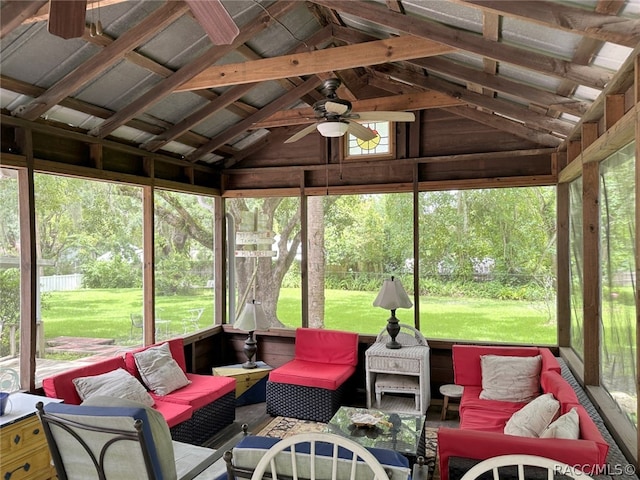 sunroom featuring vaulted ceiling with beams and ceiling fan