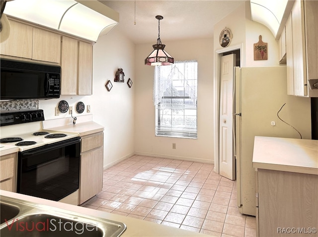 kitchen featuring range with electric cooktop, light brown cabinetry, hanging light fixtures, white fridge, and light tile patterned floors