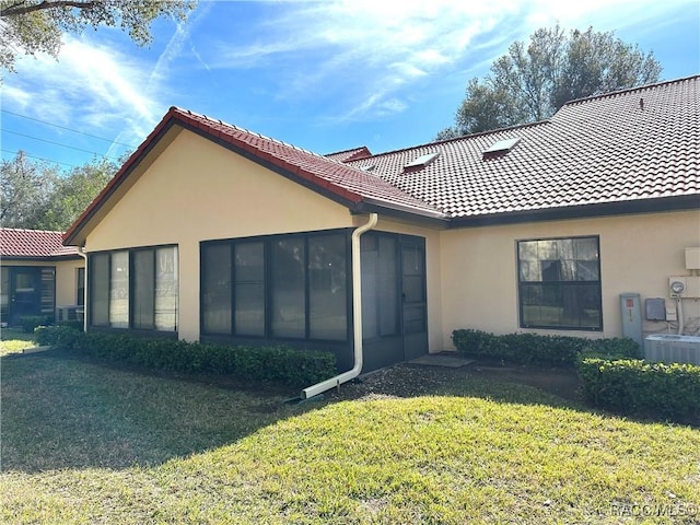 view of home's exterior featuring a yard and central AC unit