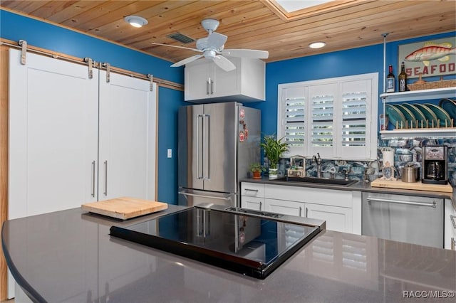 kitchen featuring white cabinetry, sink, ceiling fan, wooden ceiling, and appliances with stainless steel finishes