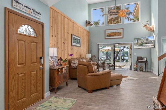 entryway featuring plenty of natural light, light wood-type flooring, and a high ceiling