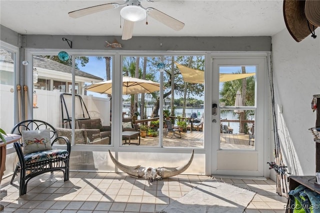 sunroom / solarium featuring a wealth of natural light and ceiling fan