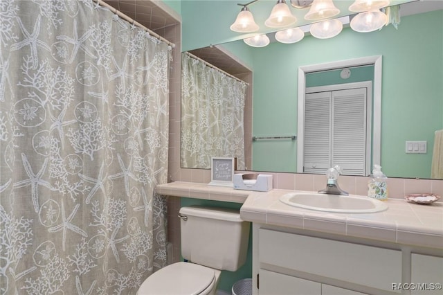 bathroom featuring vanity, toilet, and curtained shower