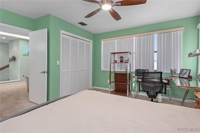 carpeted bedroom with ceiling fan and a closet