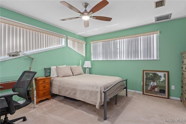 bedroom with ceiling fan and light carpet