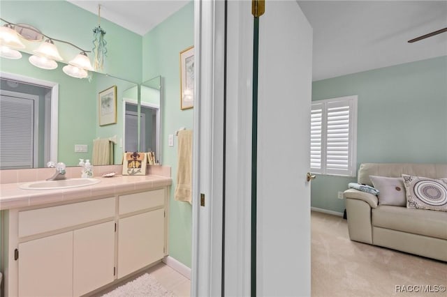 bathroom with ceiling fan and vanity