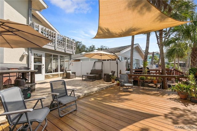 wooden deck featuring a sunroom and a patio area