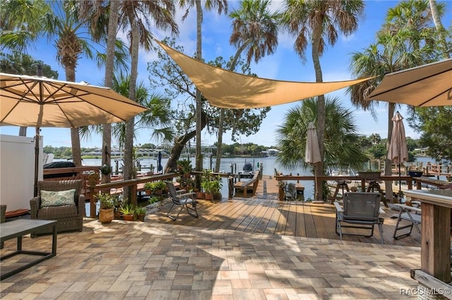 view of patio / terrace with a boat dock and a water view