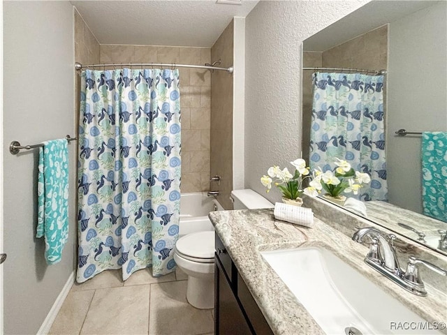 full bath with a textured wall, toilet, vanity, a textured ceiling, and tile patterned floors