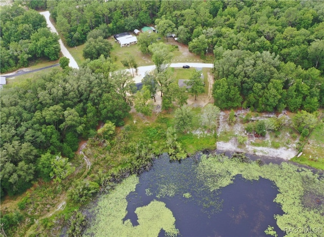 aerial view with a water view and a wooded view