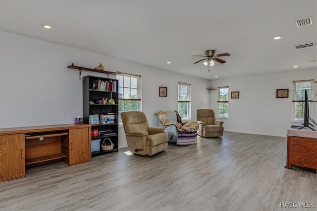 sitting room with visible vents, light wood-style floors, and plenty of natural light