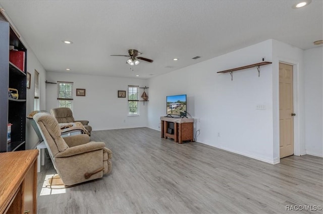 living area featuring a ceiling fan, recessed lighting, wood finished floors, and visible vents