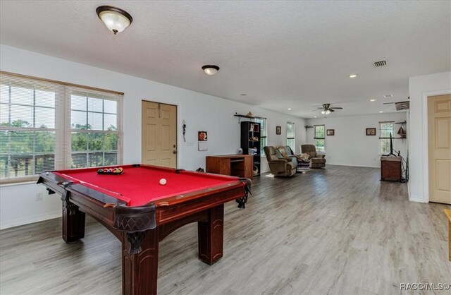 playroom featuring billiards, a ceiling fan, wood finished floors, and a wealth of natural light