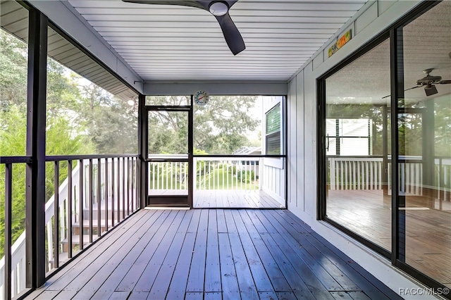 unfurnished sunroom featuring a wealth of natural light and ceiling fan