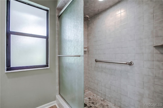 bathroom with a tile shower