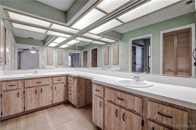 bathroom featuring hardwood / wood-style floors, vanity, and ceiling fan