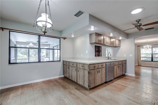 kitchen with dishwasher, ceiling fan with notable chandelier, sink, hanging light fixtures, and light hardwood / wood-style floors