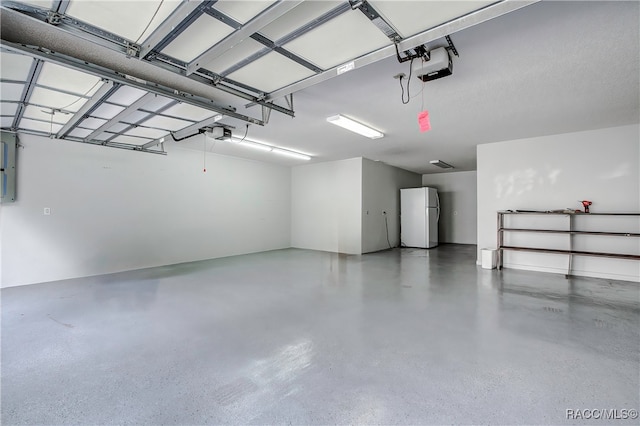 garage with electric panel, a garage door opener, and white refrigerator