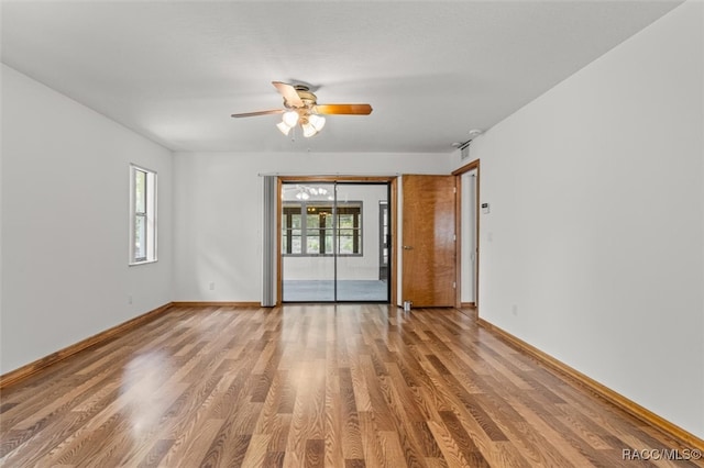 unfurnished room with hardwood / wood-style flooring and ceiling fan