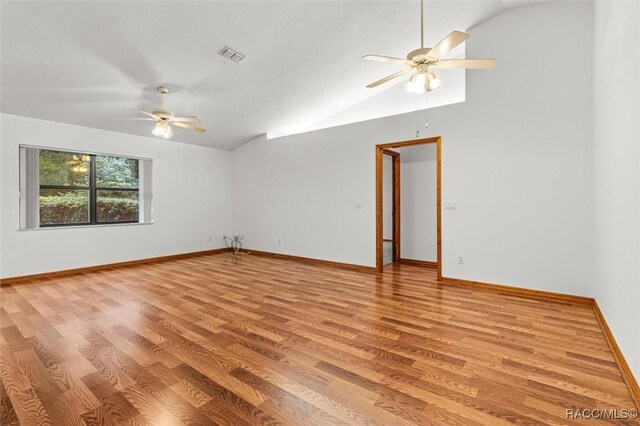 2494 W Axelwood Dr, Beverly Hills, FL 34465 - unfurnished room featuring lofted ceiling, visible vents, light wood-style floors, a ceiling fan, and baseboards