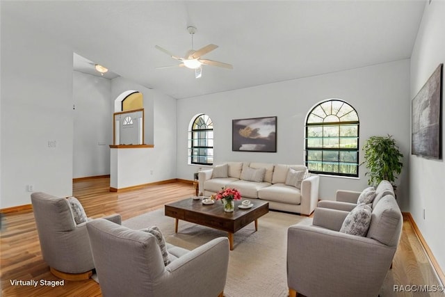 2494 W Axelwood Dr, Beverly Hills, FL 34465 - living area with lofted ceiling, light wood-style flooring, and baseboards