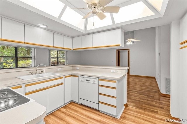 2494 W Axelwood Dr, Beverly Hills, FL 34465 - kitchen with light countertops, dishwasher, a peninsula, and white cabinetry