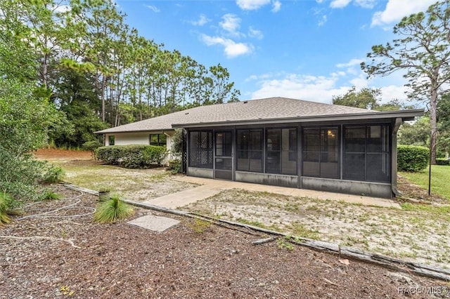 2494 W Axelwood Dr, Beverly Hills, FL 34465 - rear view of house with a sunroom and roof with shingles