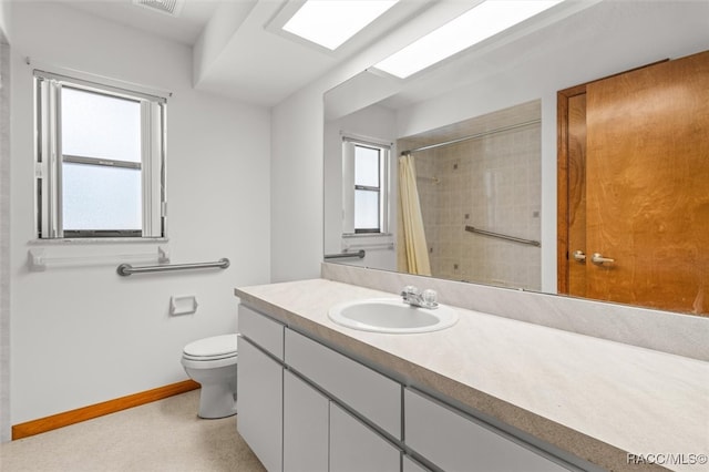 bathroom featuring vanity, a shower with shower curtain, and toilet