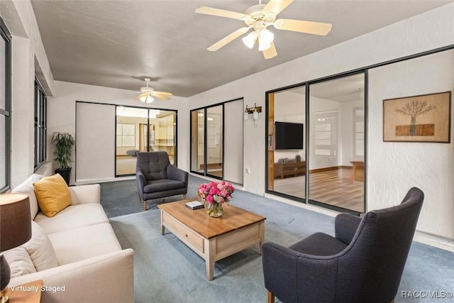 2494 W Axelwood Dr, Beverly Hills, FL 34465 - living area with a textured wall, carpet, and a ceiling fan