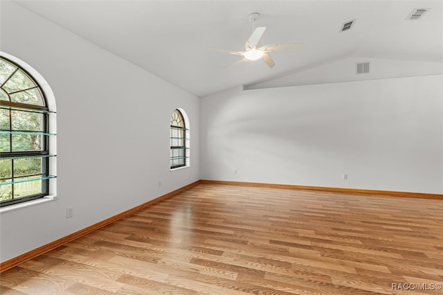 spare room featuring light hardwood / wood-style floors, ceiling fan, and lofted ceiling