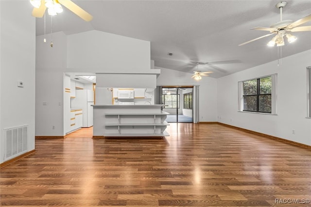 unfurnished living room featuring ceiling fan, high vaulted ceiling, and dark wood-type flooring