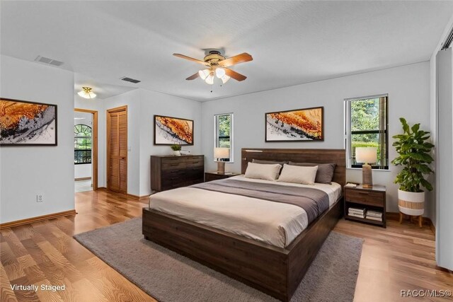 hall with hardwood / wood-style floors and a textured ceiling